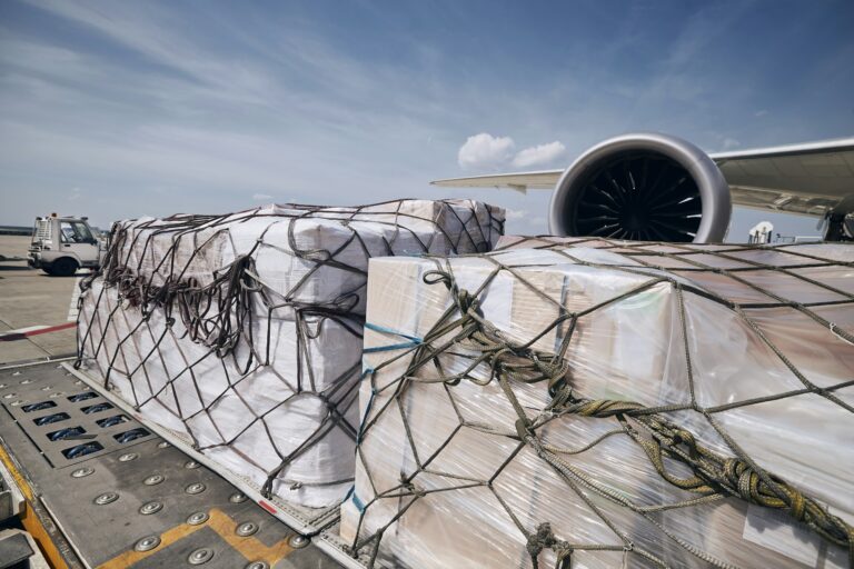 Cargo containers against jet engine of freight airplane