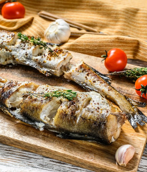 Oven baked pollock cooked in a savory marinade. White background. Top view